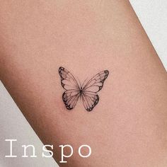 a small butterfly tattoo on the right side of the leg, with words inspo above it