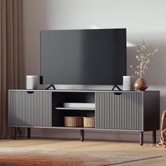 a flat screen tv sitting on top of a wooden entertainment center