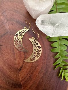 Long crescent moon earrings with floral cutouts.  // materials // - brass // size //  - earrings measure about 1.75 inches long Moon Phase Earing Jewelry, Organic Jewelry Design, Textured Gold Earrings, Hawaii Crafts, Afro Jewelry, Faberge Jewelry, Big Moon, Earrings Moon, Floral Moon