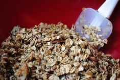 a scoop full of oats sitting on top of a red table