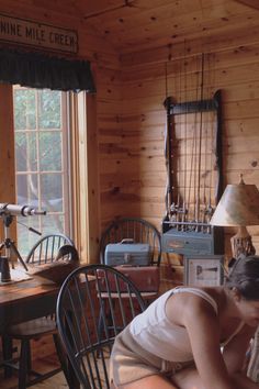 Girl leaning over table playing cards in wooden walled cabin Old Cabin Aesthetic, Lake Cabin Aesthetic, July Reset, Vermont Photography, Writers Retreat, Tahoe Cabin, Cabin Vibes, Lana Del Rey Albums, Old Cabin