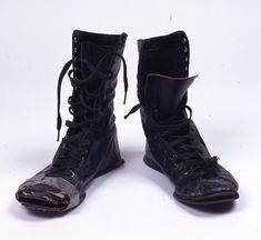 an old pair of black leather boots with laces