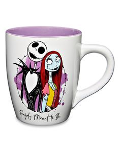 a white coffee mug with a cartoon character on the front and purple rimmed inside