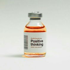 a bottle of positive thinking liquid on a white background