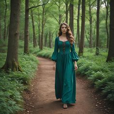 a woman in a green dress is walking through the woods