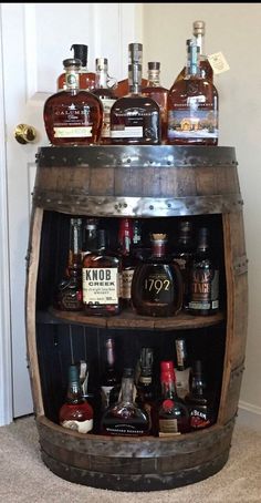 an old wooden barrel filled with liquor bottles