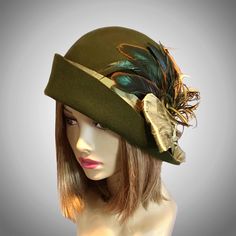 This beautiful Loden/Olive colored ladies cloche is made from fur felt, and hand draped over an antique hat block. This hat is embellished with a silk dupioni sash, and feathers.  I personally create each hat one at a time, and no two are ever exactly the same.  My hats are 100% handmade for you using traditional Millinery techniques and the highest quality fabrics and details.  Please allow 2-3 weeks before shipping, unless otherwise agreed upon. Please indicate your head size measurement when Art Hats, Antique Hat, Loden Green, Cloche Hats, Flapper Hat, Hat Blocks, Silk Dupioni, Antique Hats, Millinery Hats