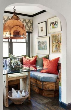 a living room filled with lots of furniture and pictures on the wall above it's glass top coffee table