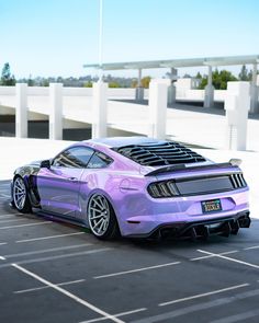 a purple sports car parked in a parking lot