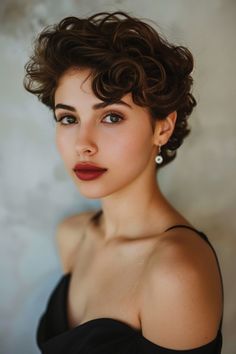 Elegant woman with curly hair and subtle makeup looking at the camera, wearing a black dress and a dainty earring. Curly Pixie Hairstyles, Shaggy Pixie, Short Curly Haircuts, Pixie Bob