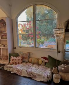 a living room filled with lots of furniture and a large window over the top of it