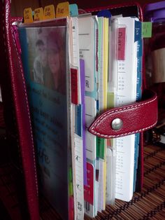 a red leather book holder holding several books