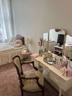 a bedroom with a chair, desk and mirror