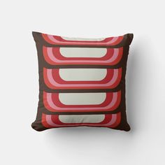 a brown and red pillow with an abstract design