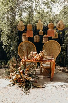 two wicker chairs sitting next to each other on top of a floor covered in flowers