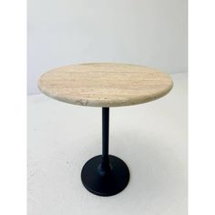 a round marble table with black metal base