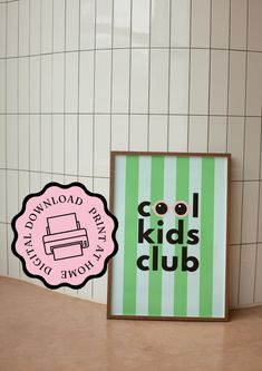 there is a sign that says cool kids club next to a wall with white tiles