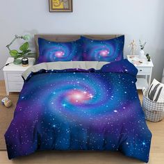 a bed with purple and blue comforters in a bedroom