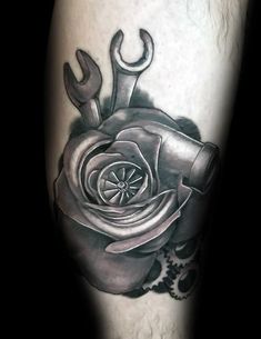 a black and grey rose with wrenches on the leg tattoo design for mens legs