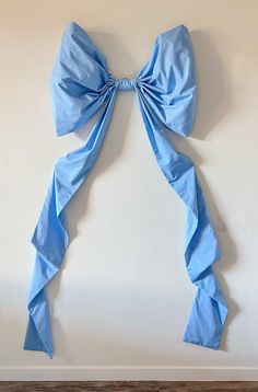 a blue bow is hanging on the wall