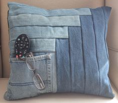 a pillow that has a remote control in it and some other items sticking out of the pocket