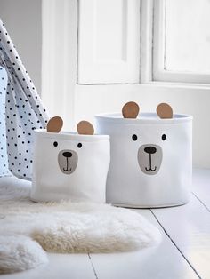 two white storage bins with bear faces on them