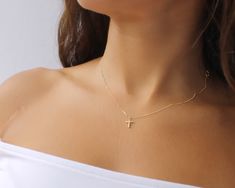 "This 14K Solid Gold Cross Necklace is a perfect gift for a friend loved one or treat yourself. It will add a perfect dainty touch to any look.  The chain is this beautiful .7mm Diamond cut chain.  Model wearing size 16\" necklace. This is all made of 14K Gold This Necklace comes with a Certificate of Authenticity. ● ITEM DETAILS ●  ◦ 14K Gold chain .7mm chain ◦ Tiny 14K Gold cross size 11.7mm x 7.8mm Browse the rest of our collection here: www.etsy.com/shop/beaucoupdebeads ● HOW TO ORDER ● Plea Gold Key Necklace, Cross Necklace Gold, Key Charm Necklace, Tiny Cross Necklace, Dainty Cross Necklace, Cross Charm Necklace, Minimalist Necklace Gold, Gold Cross Necklace, Initial Necklace Gold