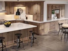 a large kitchen with wooden cabinets and white counter tops, black bar stools and an island in the middle