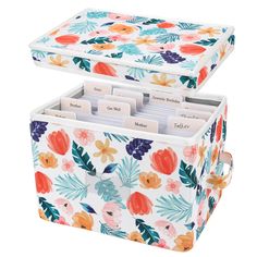 a floral pattern storage box with two compartments and dividers on the bottom, filled with notes