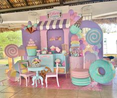 an outdoor candy shop with lots of colorful decorations on the front and side walls, decorated in pastel colors