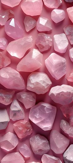 many pink rocks are arranged together on the ground