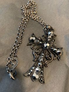 Black plated cross pendant with an adjustable chain and hematite crystals. Beautiful piece and fun to wear. Black Metal Cross Necklace With Adjustable Chain, Gunmetal Cross Metal Jewelry, Princesa Emo, Ribbon Cross, Crystals Beautiful, Goth Jewelry, Jewelry Accessories Ideas, Dope Jewelry, Funky Jewelry