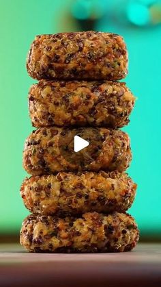 a stack of cookies sitting on top of a wooden table next to a green wall