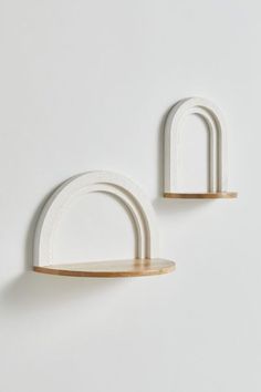 two white wooden shelves on the wall