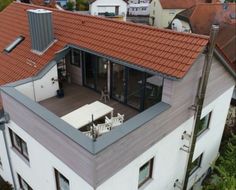 an aerial view of a house with red roof tiles on the top floor and windows