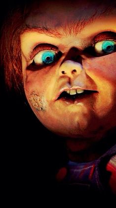 a creepy doll with blue eyes and red hair