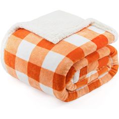 an orange and white checkered blanket folded on top of each other