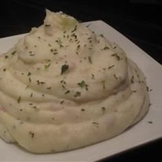 a white plate topped with mashed potatoes on top of a table