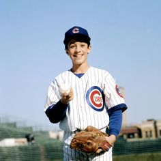 a baseball player giving the thumbs up while wearing a catchers mitt and holding a glove