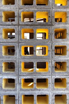 the inside of a cement structure with yellow and black squares on it's sides