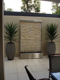 two large planters sitting on top of a patio