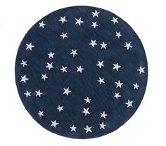 a round rug with white stars on it in dark blue and white colors, against a white background