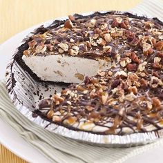 there is a pie with chocolate and nuts on it