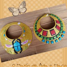 a pair of earrings with colorful designs on them