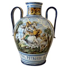 a large vase with an image of a man riding a horse on the back of it