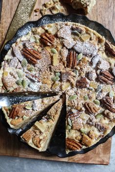 a pie with pecans and other toppings on it