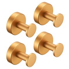 three brass colored knobs on the side of a wall