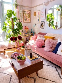 a living room filled with furniture and lots of plants on top of a coffee table