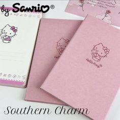 three notebooks with hello kitty designs on them are sitting next to eachother