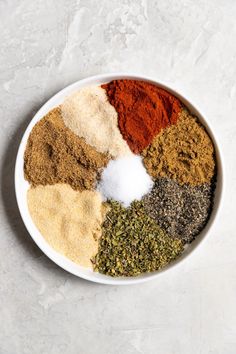 a white bowl filled with different types of spices